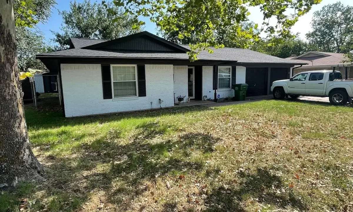 Professional roofing crew working on a residential roof in Fayetteville